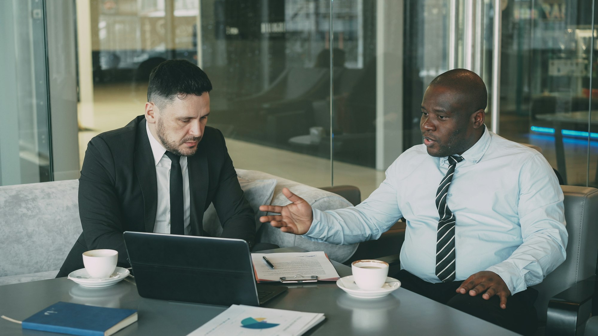 Two businessmen having a serious discussion at a table
