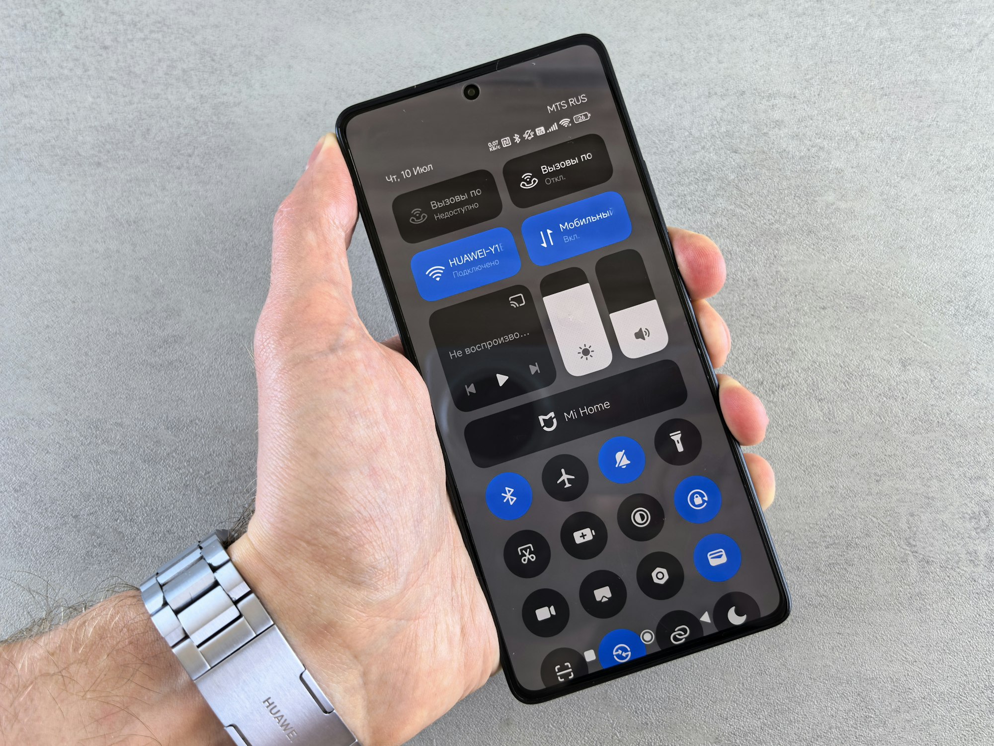 Hand holding smartphone displaying settings interface