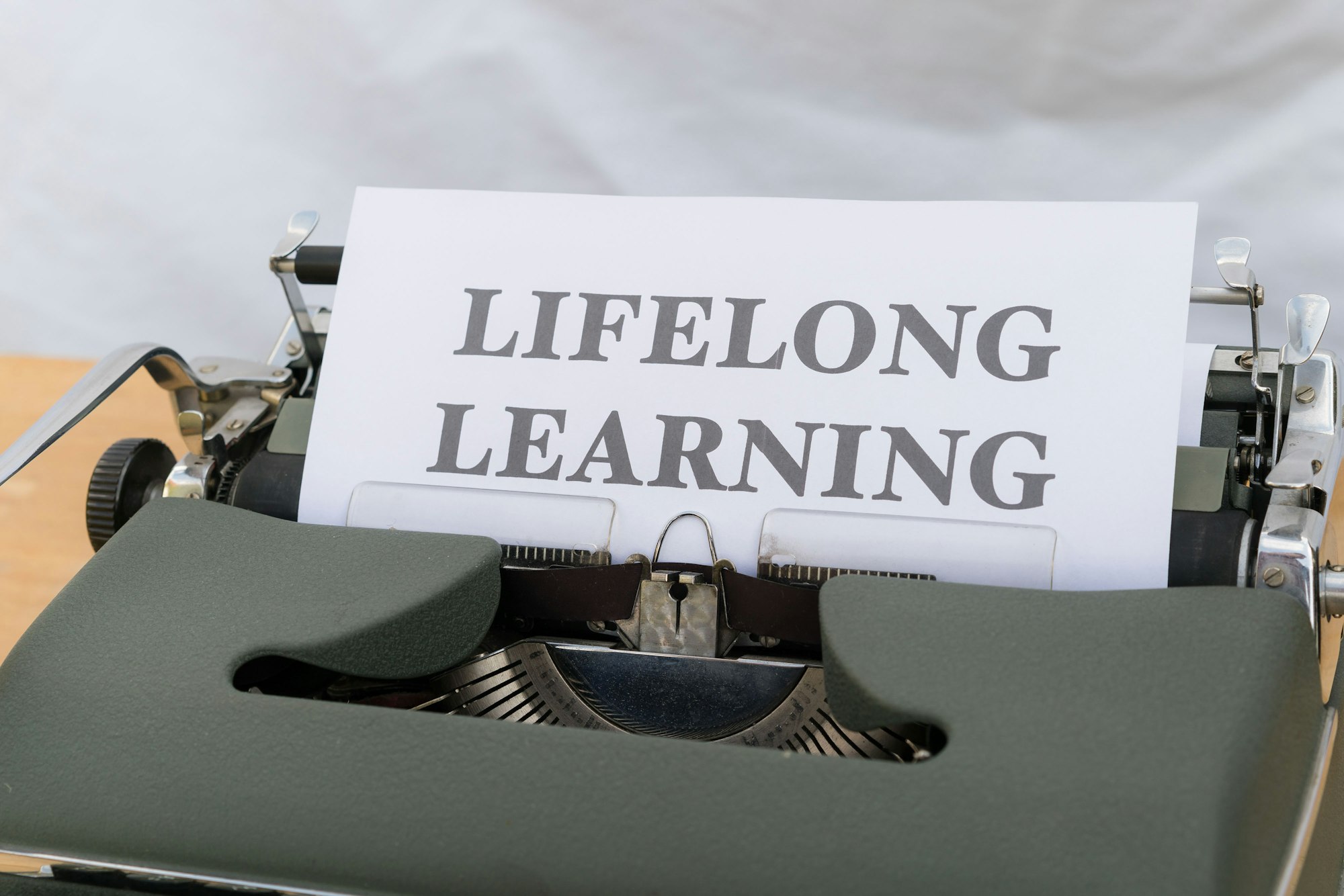 Close-up of a typewriter with a sign, representing valuable skills