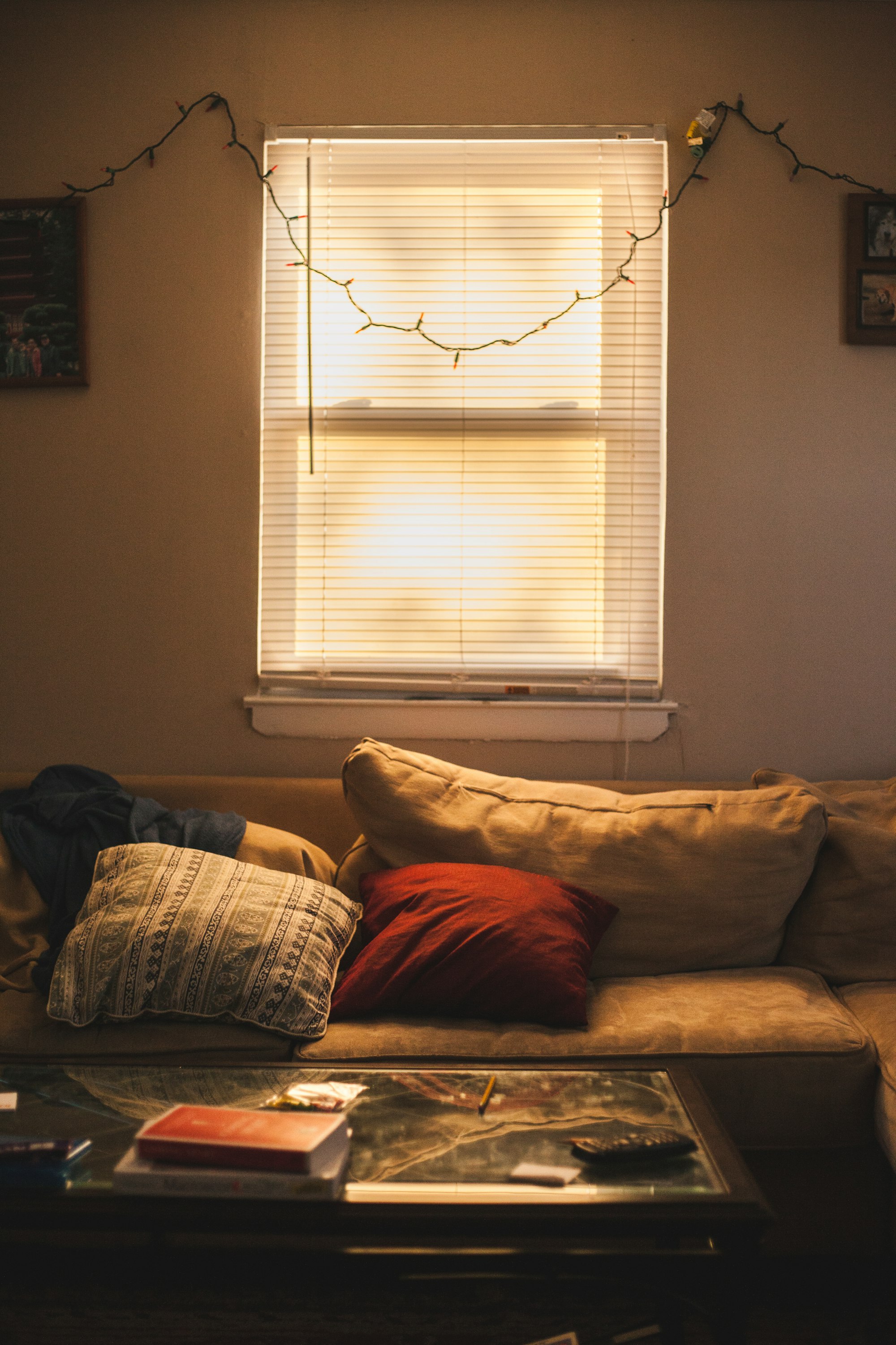 Red throw pillow on brown couch