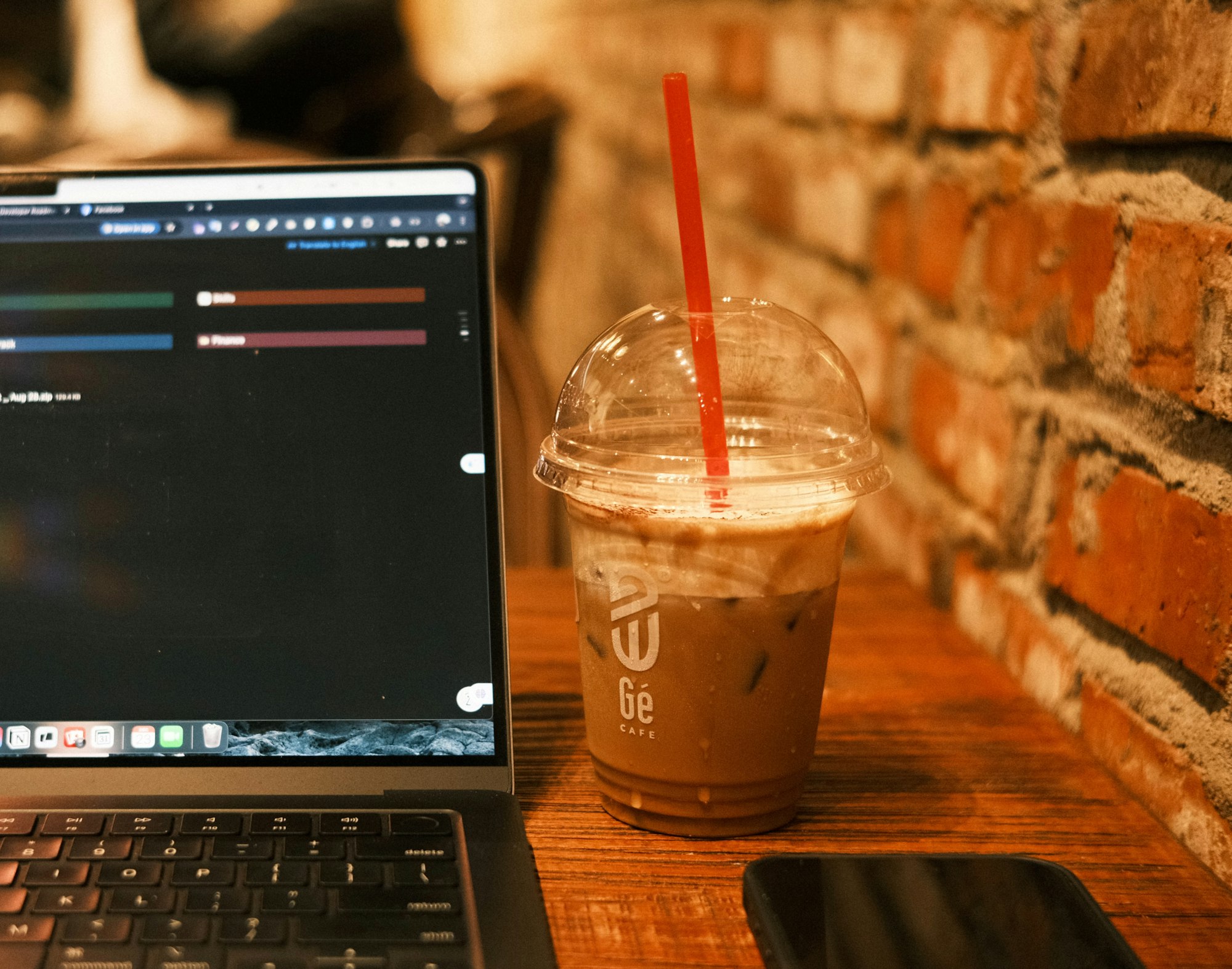 A person using a laptop on a wooden table