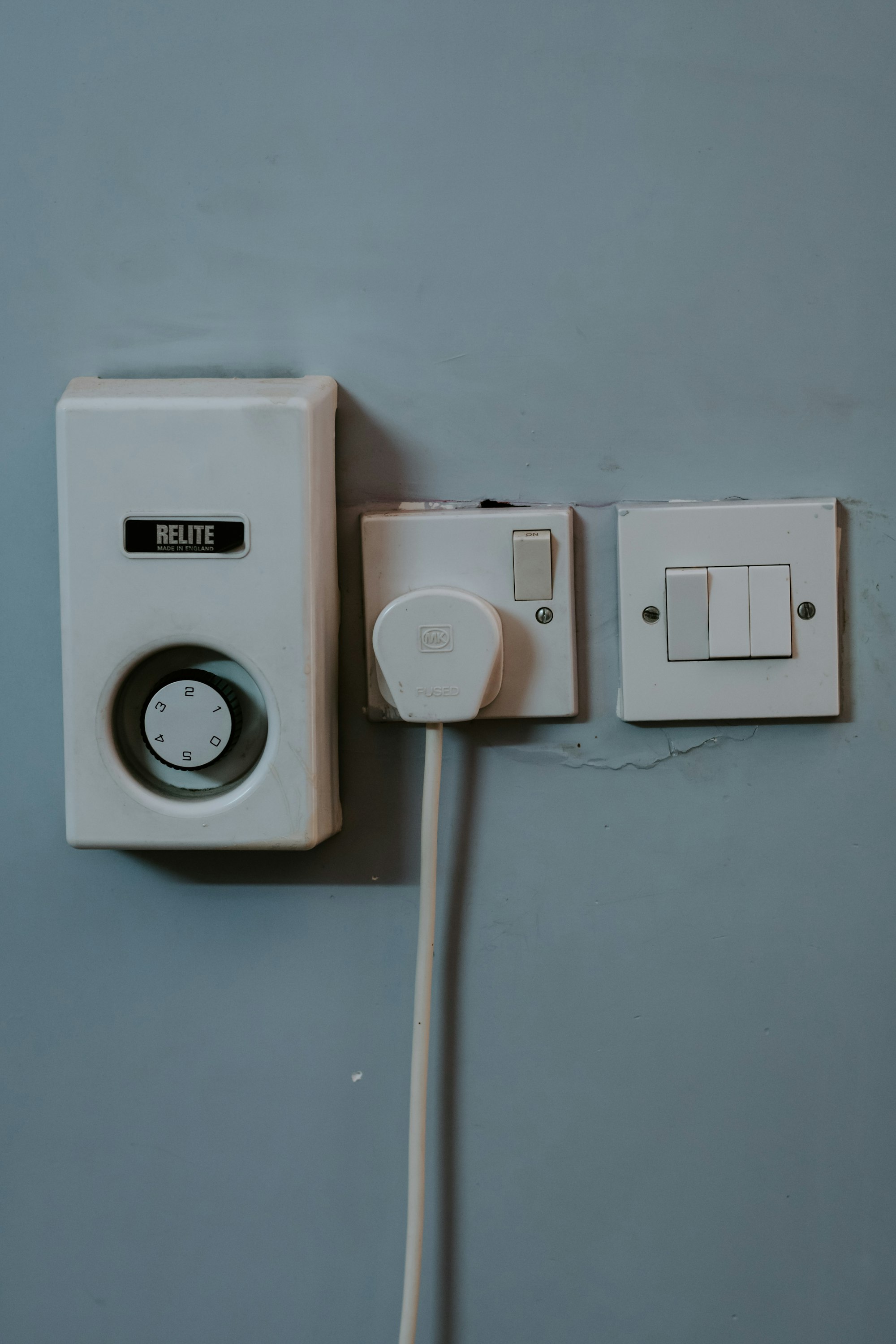 White wall mounted switch on white wall