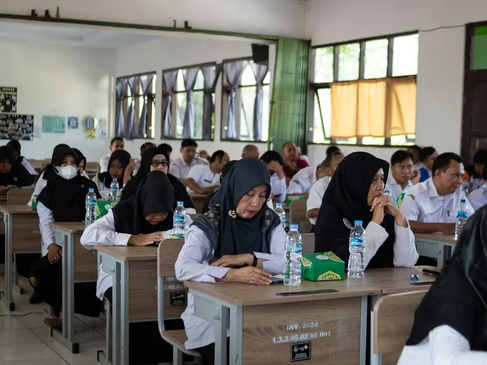Students seated at desks in a classroom
