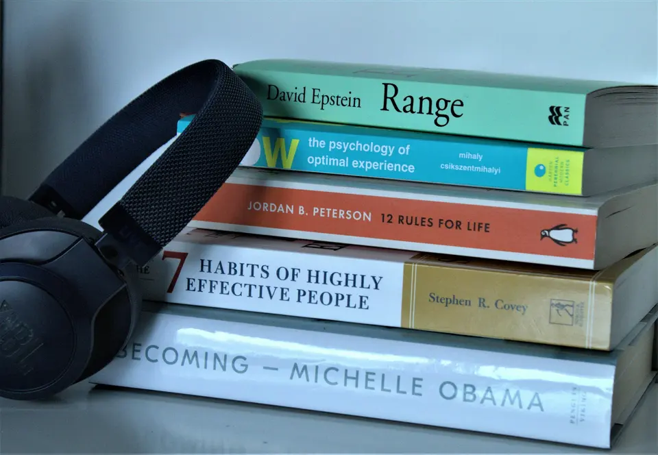 Black and green plastic containers with books