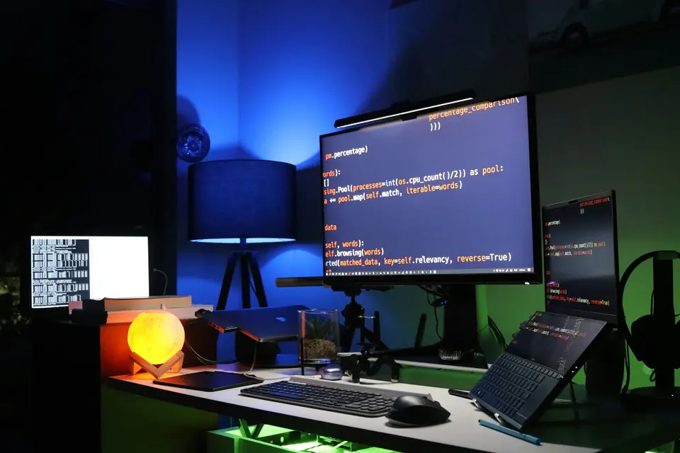 Black flat screen computer monitor on green desk