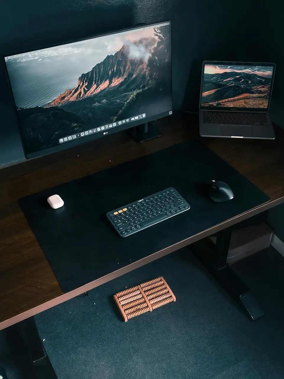 A desk with a monitor, laptop, keyboard, and mouse