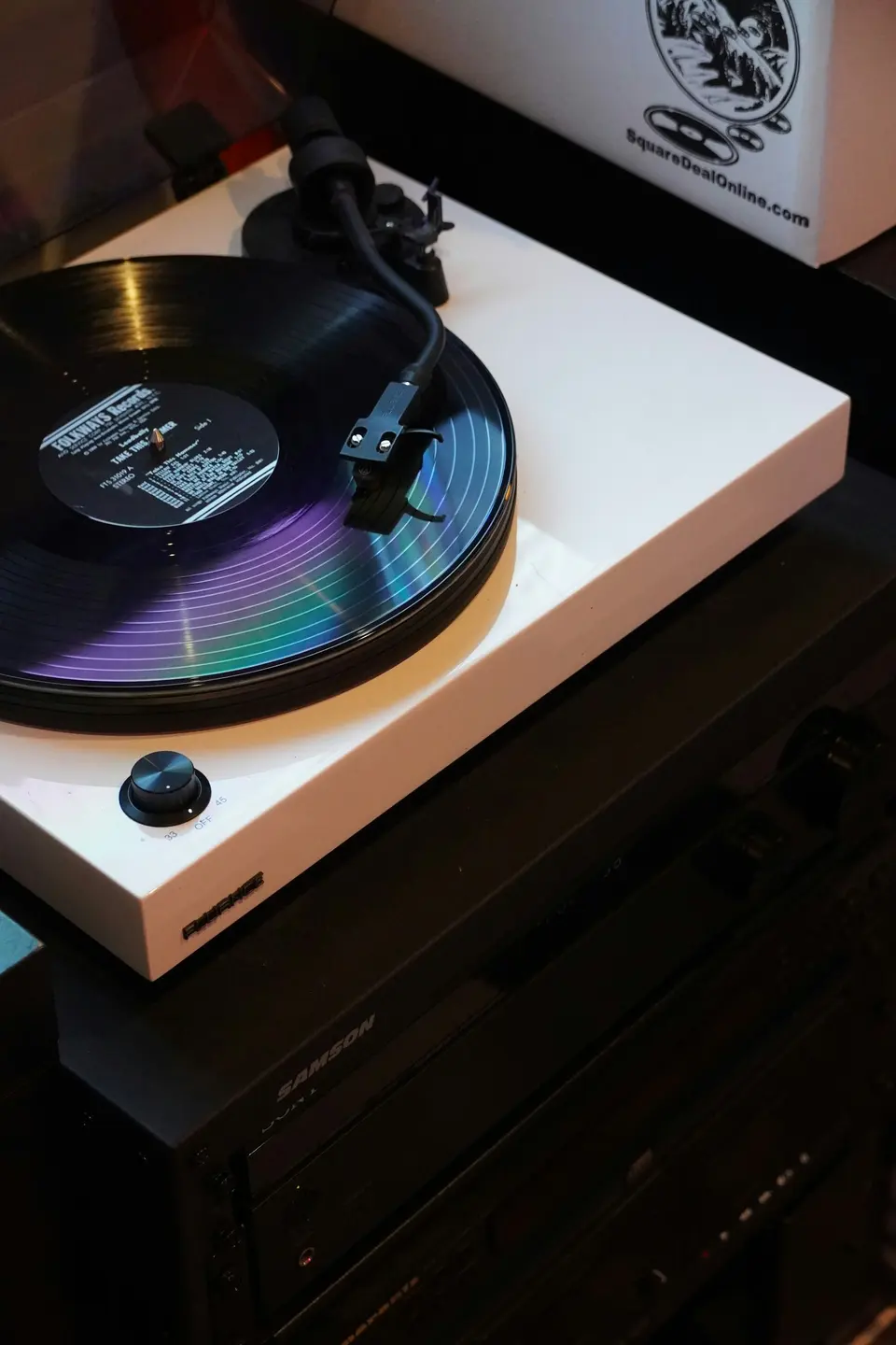 A vinyl record on a white turntable