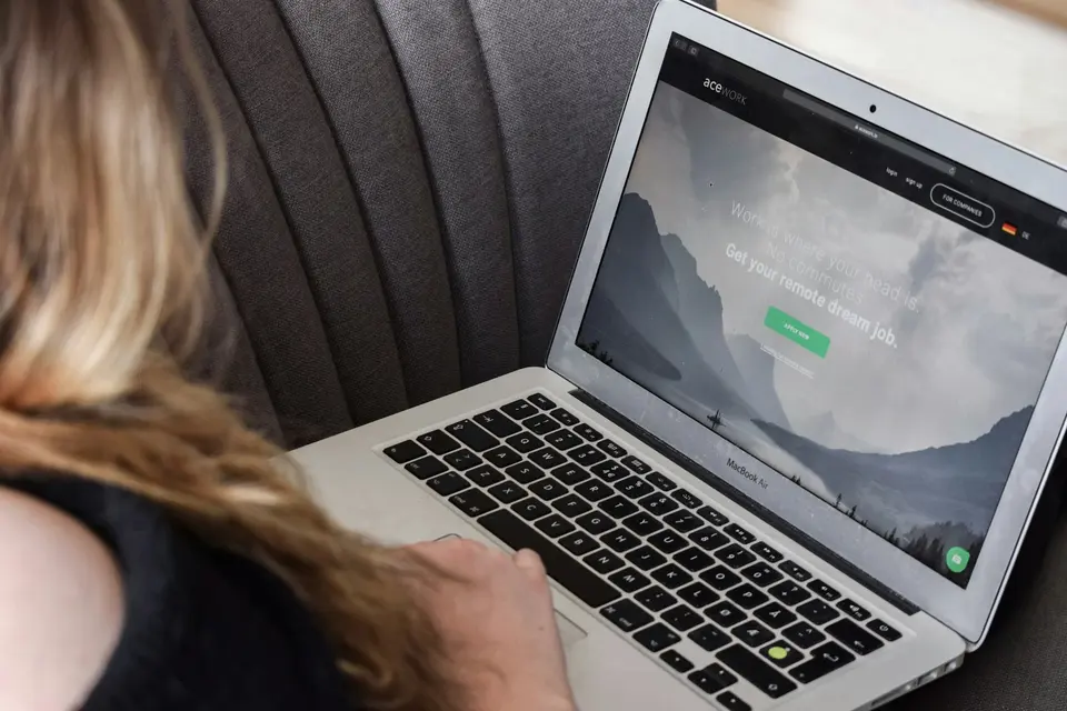 Blurred laptop with video call on screen, home office environment