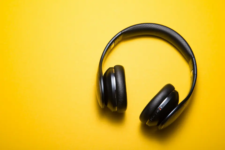 Headphones and notebook on a light background