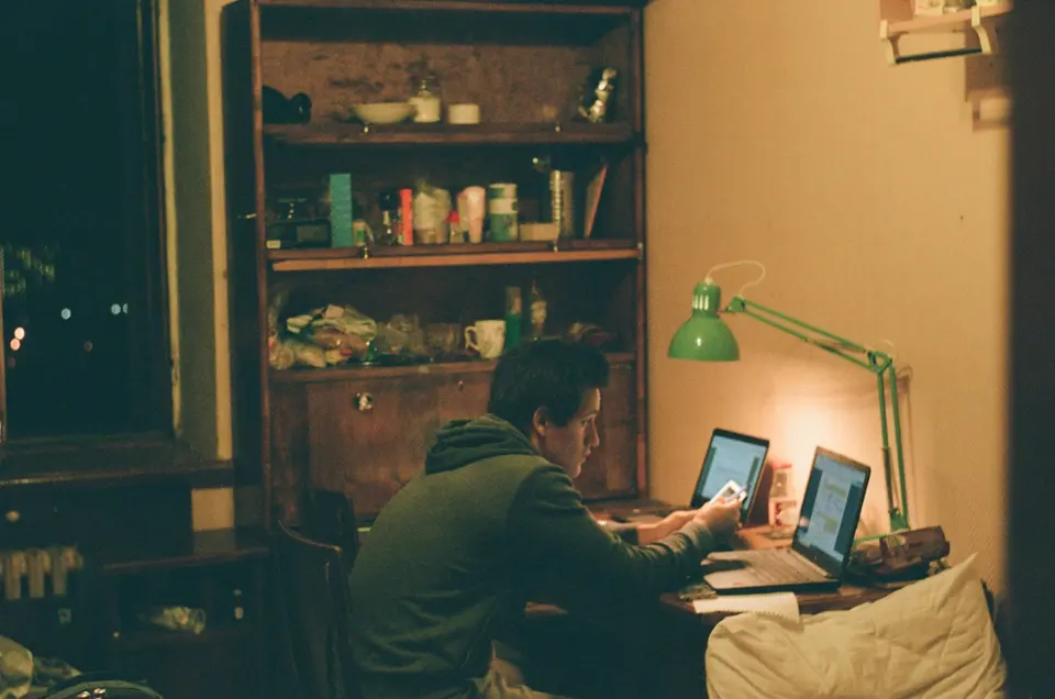 Man in black jacket using laptop computer