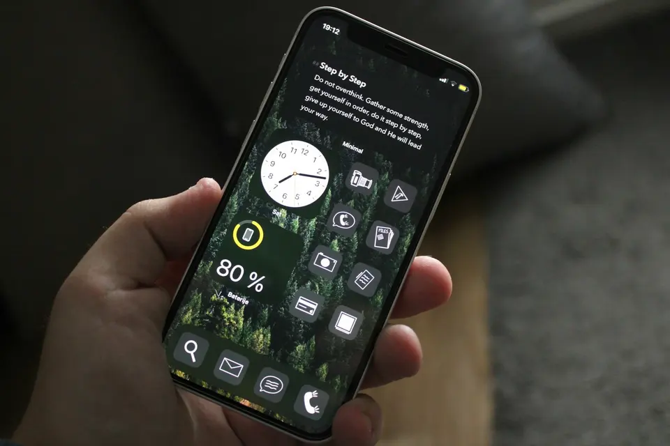 A person holding a cell phone in their hand