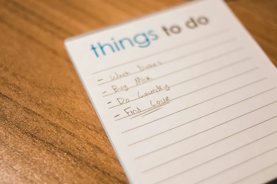 A handwritten to-do list on a lined notepad
