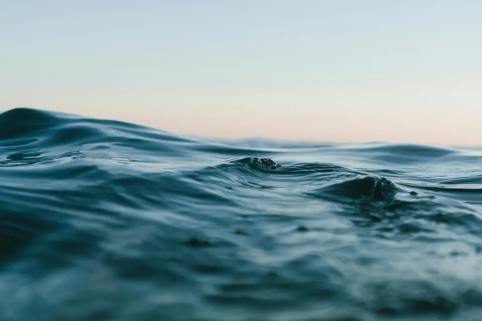 A calm body of water under an open sky