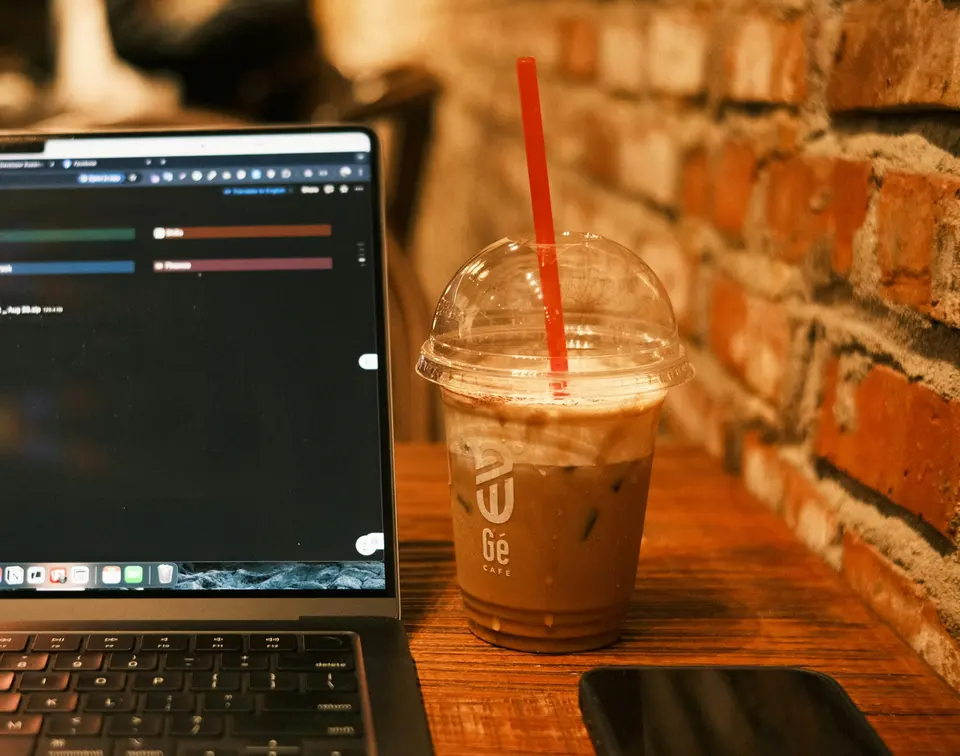 A person using a laptop on a wooden table