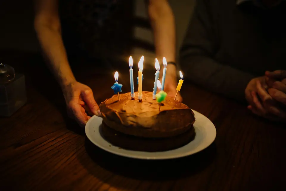 Lit candles on chocolate cake